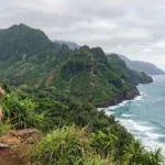 Traveler admiring Kauai coastal scenery
